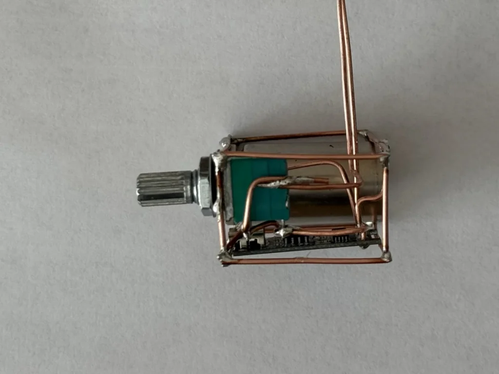 Side view of the copper base with the potentiometer knob sticking out and the copper wires holding it in place