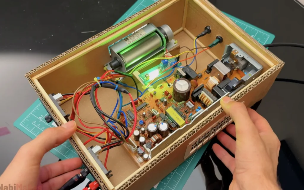 Inside of the finished DIY bench power supply with the fan, the glowing filament LED and the tidied wiring