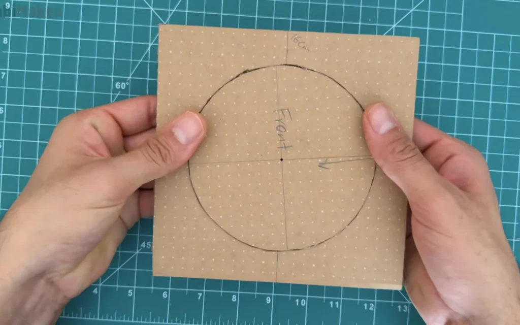 Square cardboard front panel marked 'Front' with a large drawn circle and centre lines for the fan opening