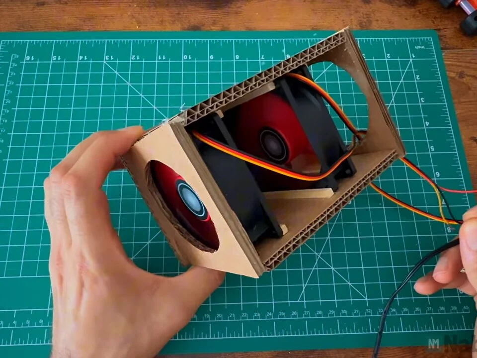 Both fans inside the box connected to a power lead for a test run
