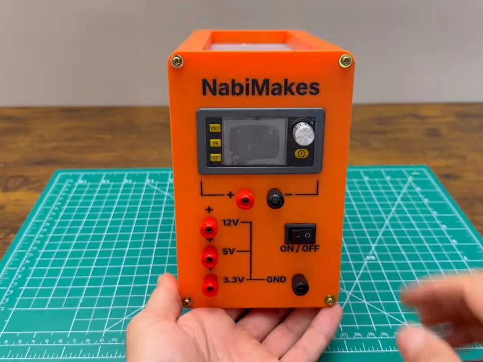 Front of the finished bench power supply with the NabiMakes name, the SK120 display, the variable output jacks and the 12 V, 5 V and 3.3 V binding posts