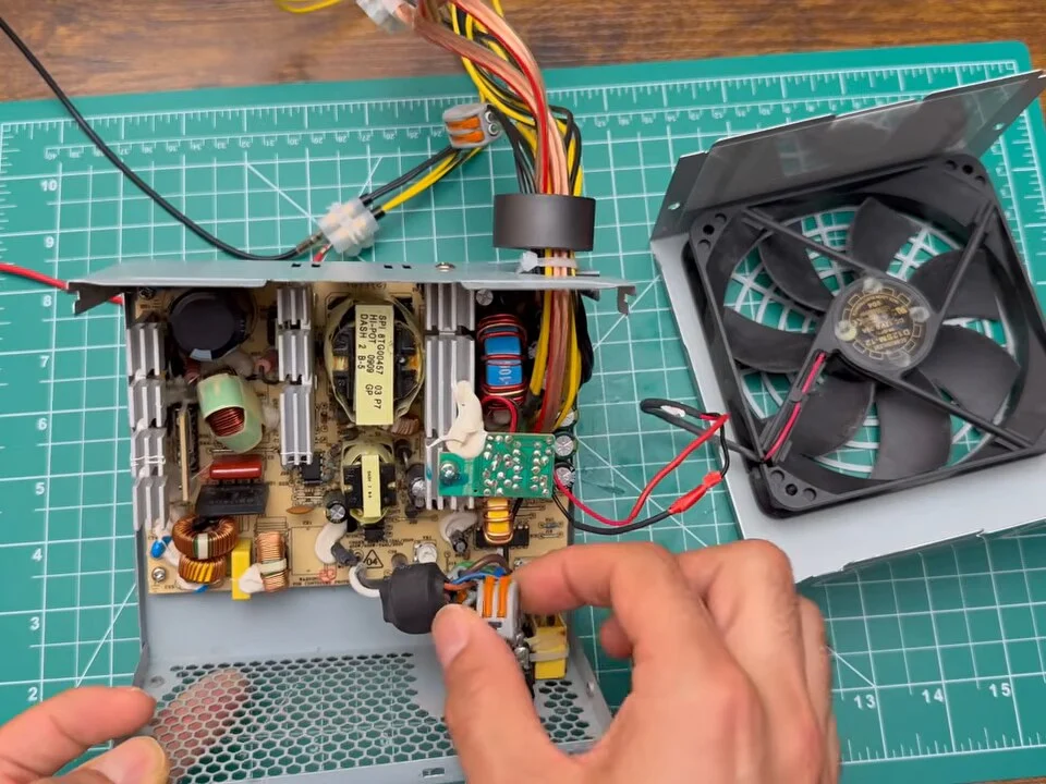 Opened PC power supply with the circuit board and the fan taken out of the metal case