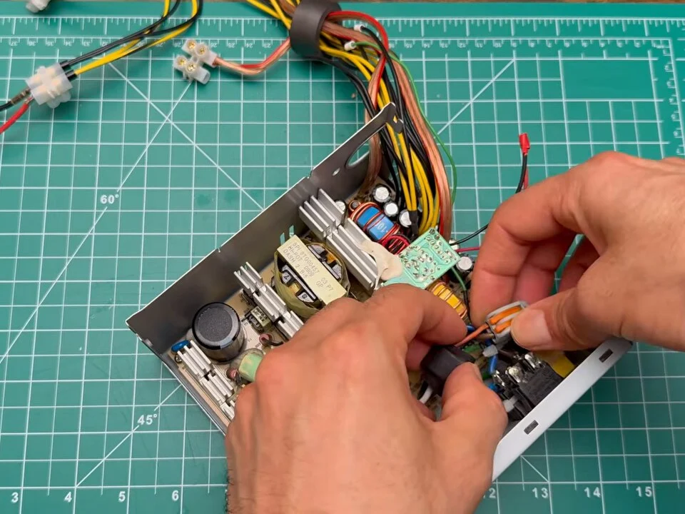 Cutting the extra wires and connectors off the power supply board
