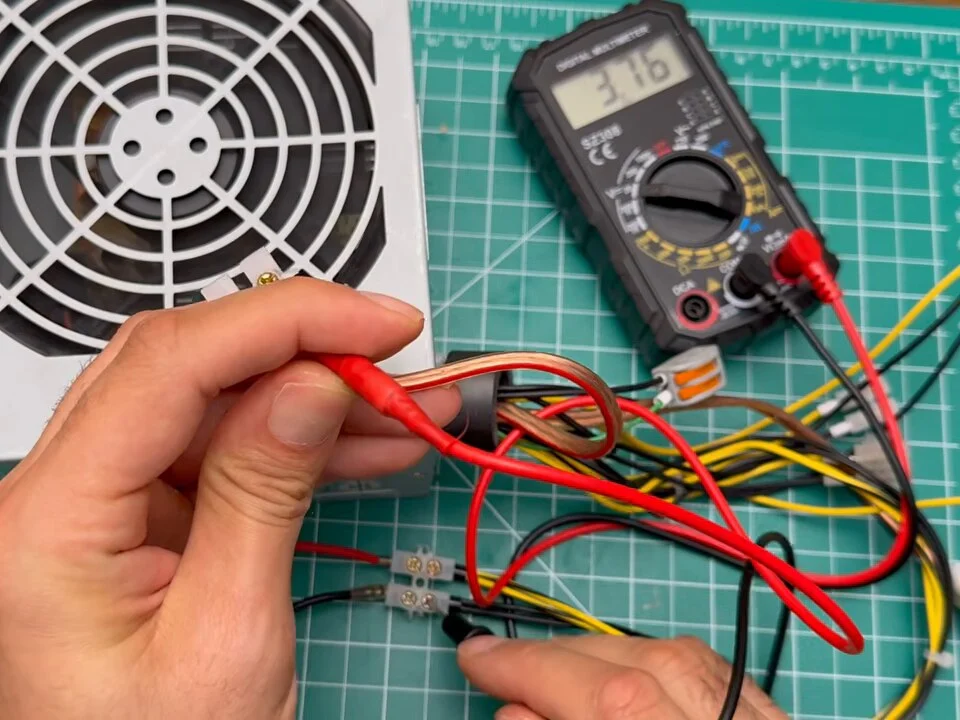 Multimeter probes on the power supply wires showing the 3.3 V rail
