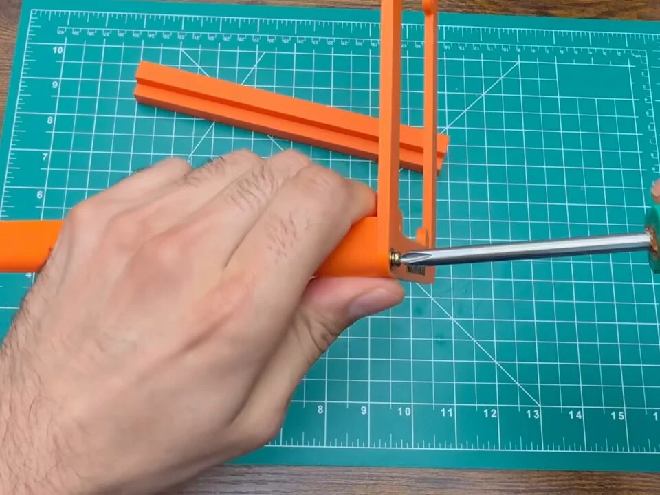 Screwdriver fastening the printed frame rails into a corner piece