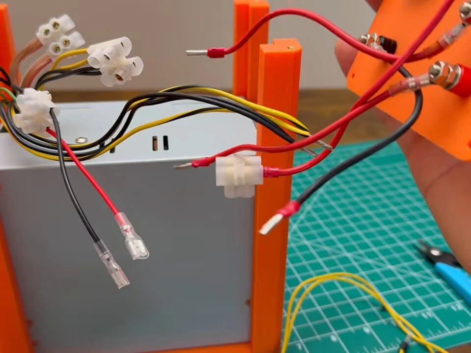 Shortened wires and terminal blocks on top of the power supply inside the frame