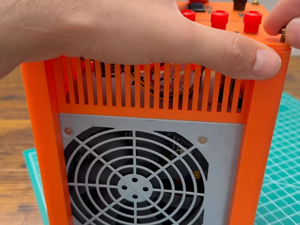 Pressing the front panel into place on top of the orange frame